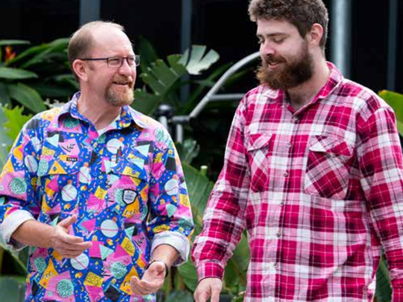 Two middle aged men chatting in the park