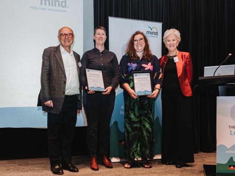 Mind Chair and CEO standing with two Stratford Scholarship recipients holding certificate awards