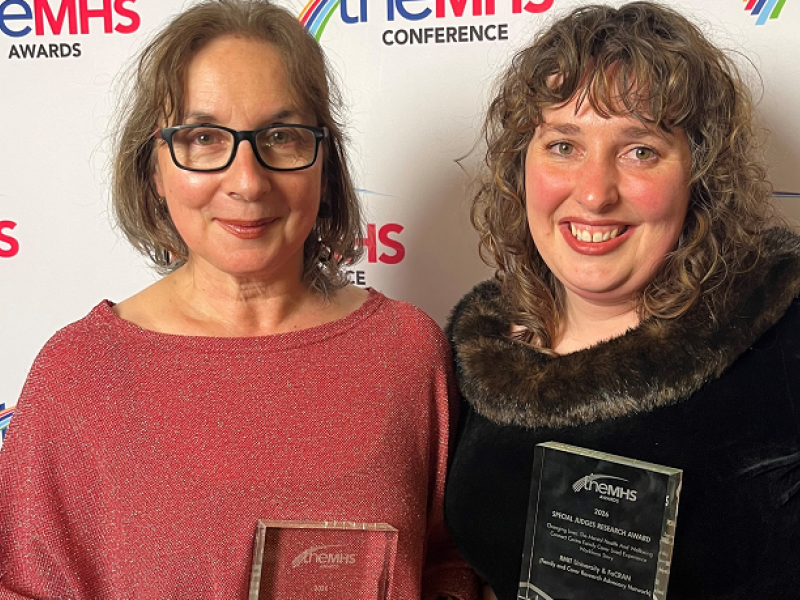 Two women holding their awards